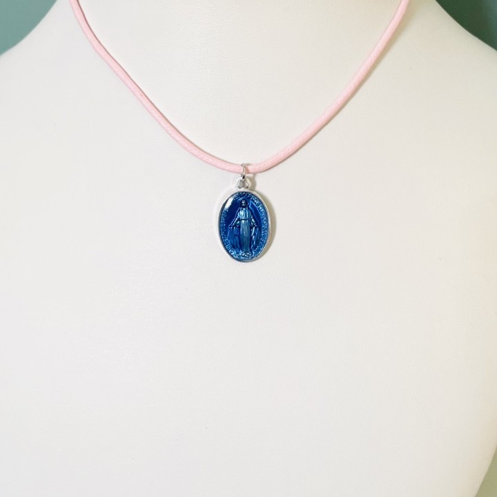Jolie médaille miraculeuse en résine bleue sur un cordon coton à nouer.